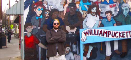 Donovan standing against a wall of graffiti
